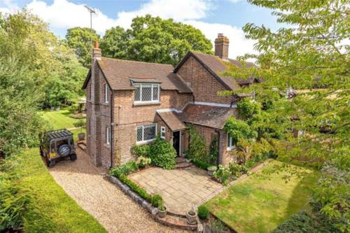 an aerial view of a brick house with a garden at Garden Lodge close to Wakehurst and Kew Seed Bank Ardingly in Ardingly