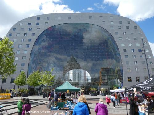 a large building with people walking in front of it at dutchduochalet2 in Heenweg