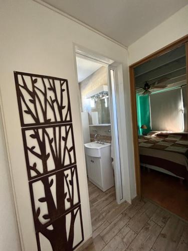 a room with a bathroom with a sink and a mirror at Luz del cielo dto PAlta in Necochea