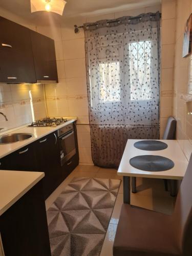 a small kitchen with a sink and a window at Two Rooms Parc Ior Apartament in Bucharest