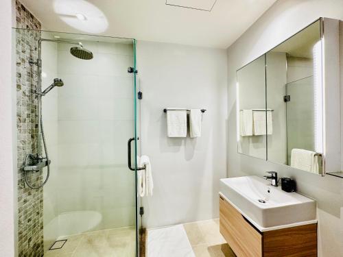 a bathroom with a shower and a sink and a mirror at Daimond Exclusive Junior Suite Bangtau Beach in Bang Tao Beach