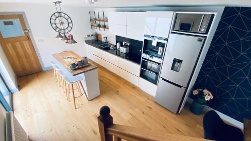 an overhead view of a kitchen with a refrigerator at Tregenna House - St Ives, A Beautiful Newly Refurbished 4 Bedroom Family Town House With Alfresco Dining Garden and Private Parking Spaces in St Ives