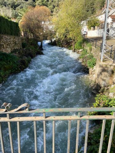 a river with white rapids on a bridge at Apartamento ANY in Benaoján