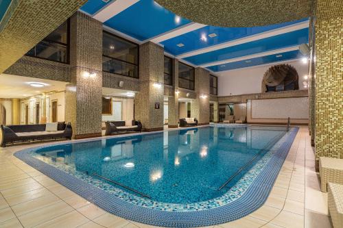 a large swimming pool in a hotel lobby at Карпатська Ружа in Plav'ya