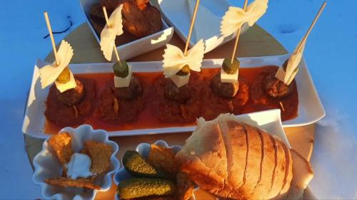 two trays of food with meat and a sandwich at Apartman Bella Vita in Kolašin