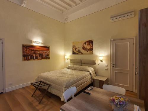 a bedroom with a bed and a table in it at RF Duomo suites in Florence