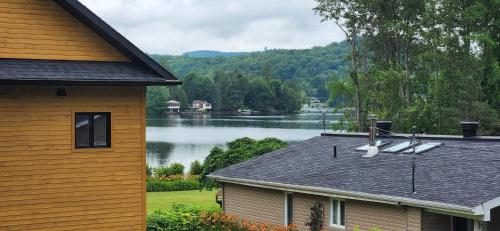 a house with a view of a lake at Le Nid doré sur le lac (Golden Nest on the lake) in Val des Monts