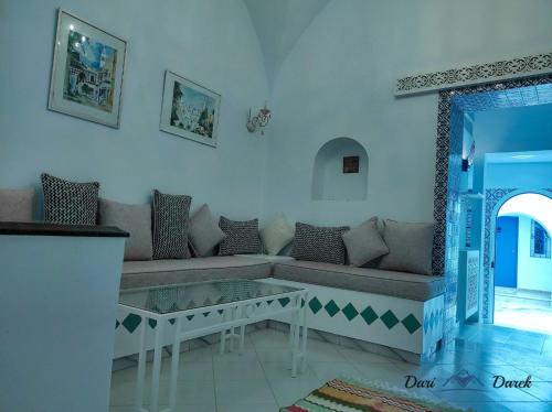 a living room with a couch and a table at studio charme in Hammamet