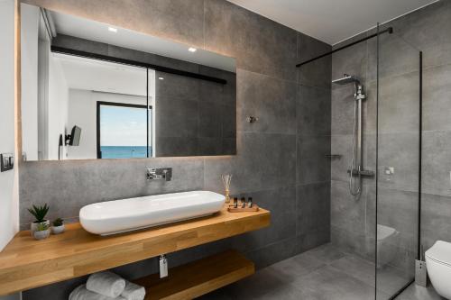a bathroom with a sink and a shower at Villa Afroditi, Corfu in Halikounas