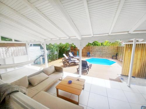 a living room with a couch and a table at La Rose du Bresil Marie-Galante in Capesterre-de-Marie-Galante