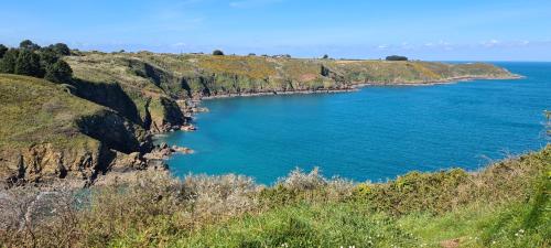 a large blue body of water on a cliff at Les Gîtes du Goelo in Plouha
