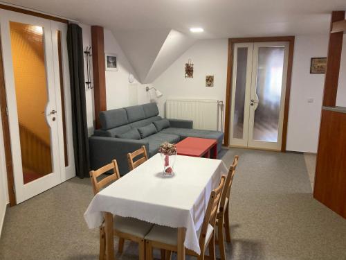 a living room with a table and chairs and a couch at Světlá nad Sázavou dům s výhledem in Světlá nad Sázavou