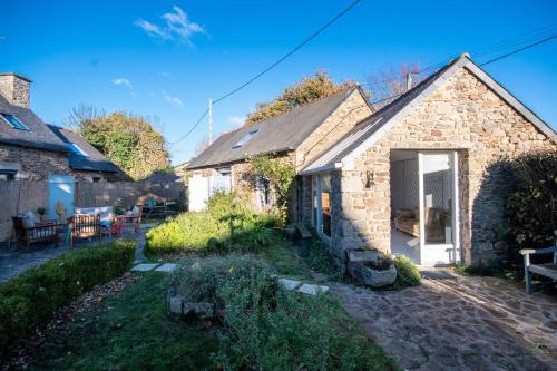 a stone house with a garden and a patio at Les Gîtes du Goelo in Plouha