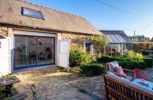 a house with a couch and a table in a yard at Les Gîtes du Goelo in Plouha