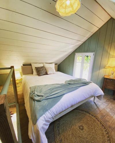 a bedroom with a bed in a attic at Les Gîtes du Goelo in Plouha