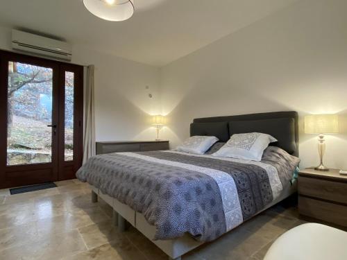 a bedroom with a large bed and a window at CHAMBRES DHOTES CORSE in Venaco