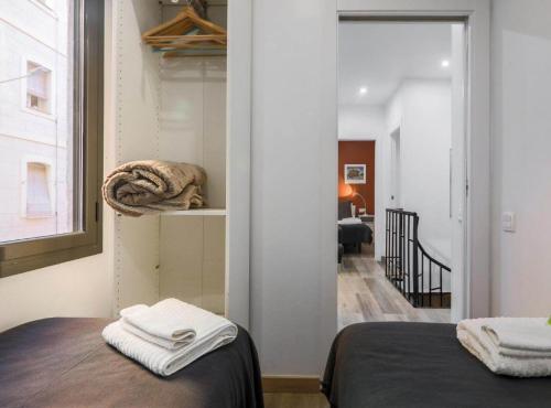 a room with a bed and a hallway with a mirror at New Listing DUPLEX NEAR THE BEACH Barceloneta in Barcelona