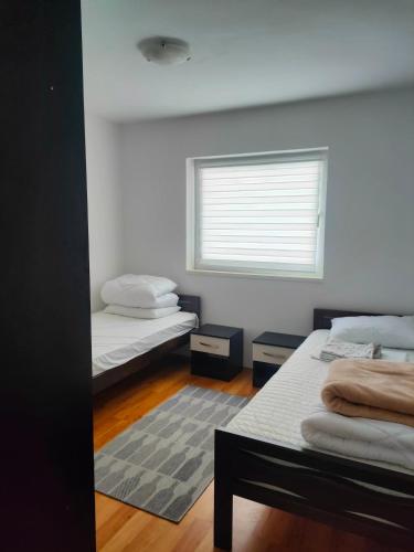 a room with two beds and a window at Depandans Stefan in Nevesinje