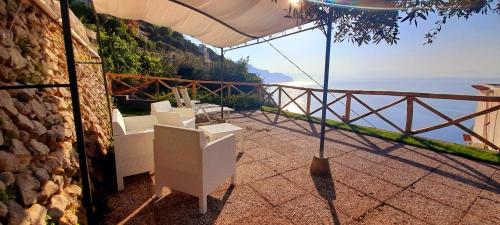 a balcony with chairs and a view of the ocean at villa lucia in Conca dei Marini