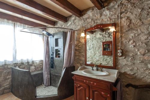 a stone bathroom with a shower and a sink at Villa with pool Can Tomeu in Es Capdellà in Capdellá