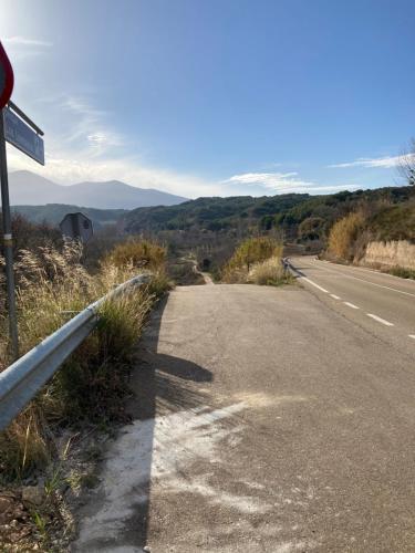an empty road with a sign on the side of the road at Casa Rural Hospital de las Palabras in Torrellas