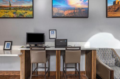 a desk with two computers and chairs in a room at Clarion Inn Kingman I-40 Route 66 in Kingman