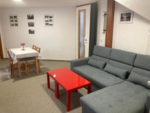 a living room with a couch and a table at Světlá nad Sázavou dům s výhledem in Světlá nad Sázavou