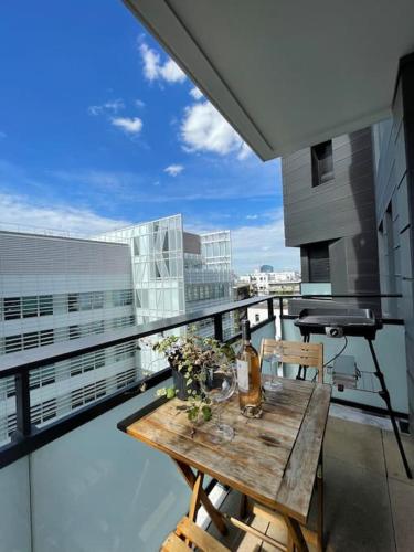 a balcony with a wooden table and a piano at Luxury & Cosy apart with balcony Eiffel Tower view in Issy-les-Moulineaux