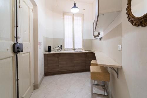 a kitchen with a sink and a window at RESIDENZA ALDROVANDI SUITE in Bologna