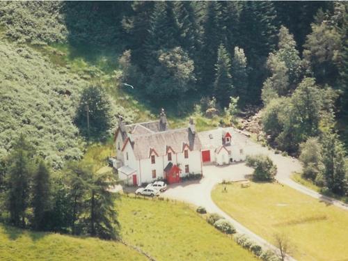 an aerial view of a large house on a hill at Inverardran House Bed and Breakfast in Crianlarich