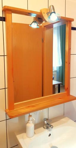 a mirror above a sink in a bathroom at Villa Hoffnung in Bad Elster