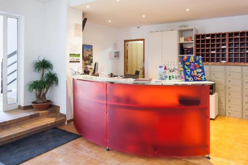 a room with a red counter in a room at Aparthotel Puerto Cala Vadella in Cala Vadella