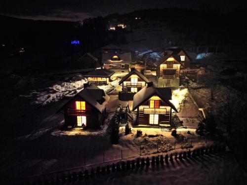 a model of a house in the snow at night at Jaworowa Osada in Brenna