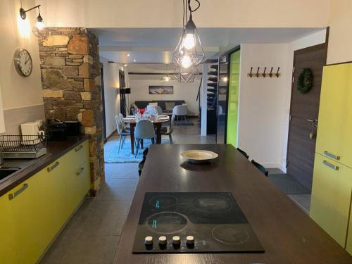 a kitchen with a counter with a stove in it at Duplex 3 chambres Vue Mont-Blanc in Domancy