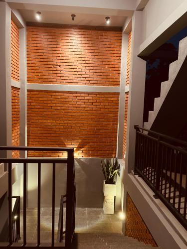 a room with a brick wall and a staircase at Coastal Hideaway in Midigama