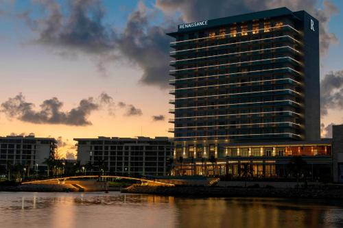 a tall building with lights on in front of a river at Renaissance Cancun Resort & Marina in Cancún