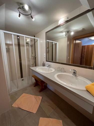 a bathroom with two sinks and a shower at Haus Alpenglühn in Schladming