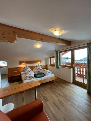 a large room with a bed and a large window at Haus Alpenglühn in Schladming
