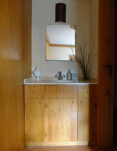 a bathroom with a sink and a mirror at Casas da Azenha do Rio in Barreiros