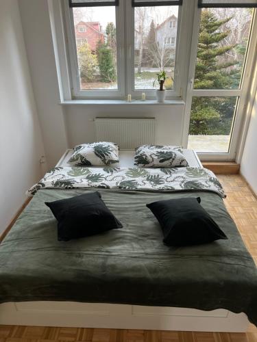 a large bed in a room with a window at Apartament Rumia 45 in Rumia