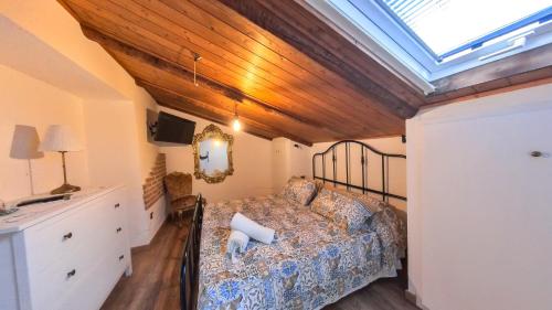 a bedroom with a bed and a skylight at Due passi dal mare in Montecorice