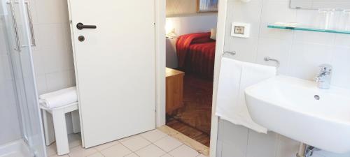 bagno con lavandino bianco e servizi igienici di Hotel Santa Lucia a Venezia
