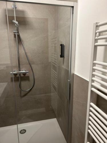 a shower with a glass door in a bathroom at Pension Residence Sonnenheim in Marlengo