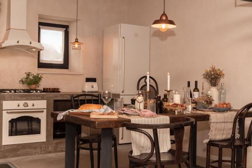 a kitchen with a table with food and wine glasses at She House - built for pleasure - Island of Brač in Gornji Humac