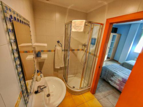 a bathroom with a shower and a sink at Hostería Sol in San Miguel de Meruelo