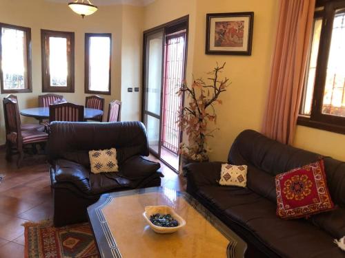 a living room with a couch and a table at Welcome to Chalet B. in Ifrane