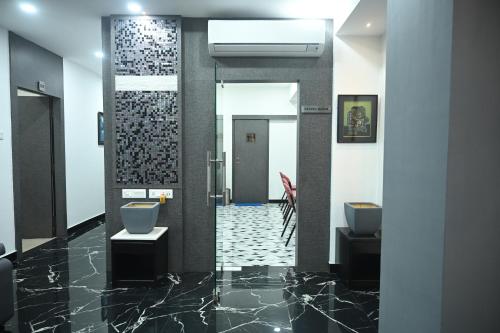 a bathroom with two toilets and a walk in shower at ELGIN SUITES in Kolkata