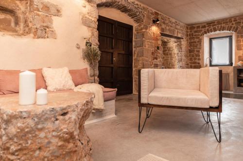a living room with a chair and a table at She House - built for pleasure - Island of Brač in Gornji Humac