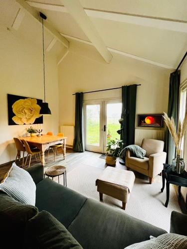 a living room with a couch and a table at IJsselgoud in Zwolle