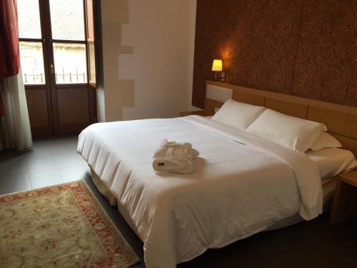 Ein Bett oder Betten in einem Zimmer der Unterkunft Grande Albergo Alfeo
